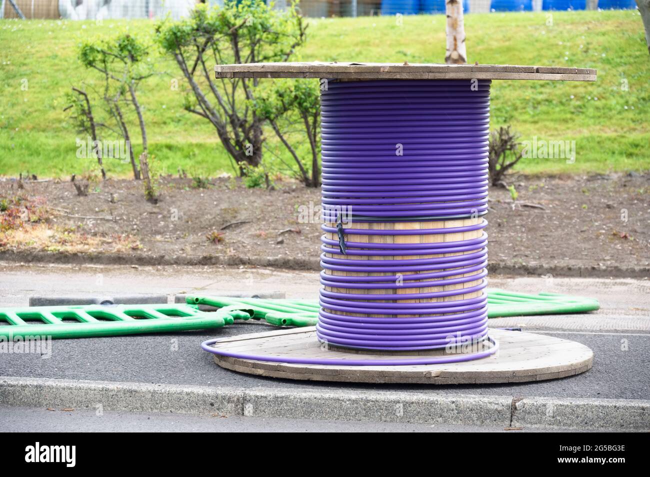 Purple cable and wooden spool with fiber optic cable for fast