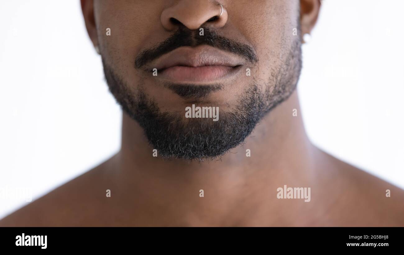 Close up of groomed beard of mixed race African guy with nose piercing Stock Photo