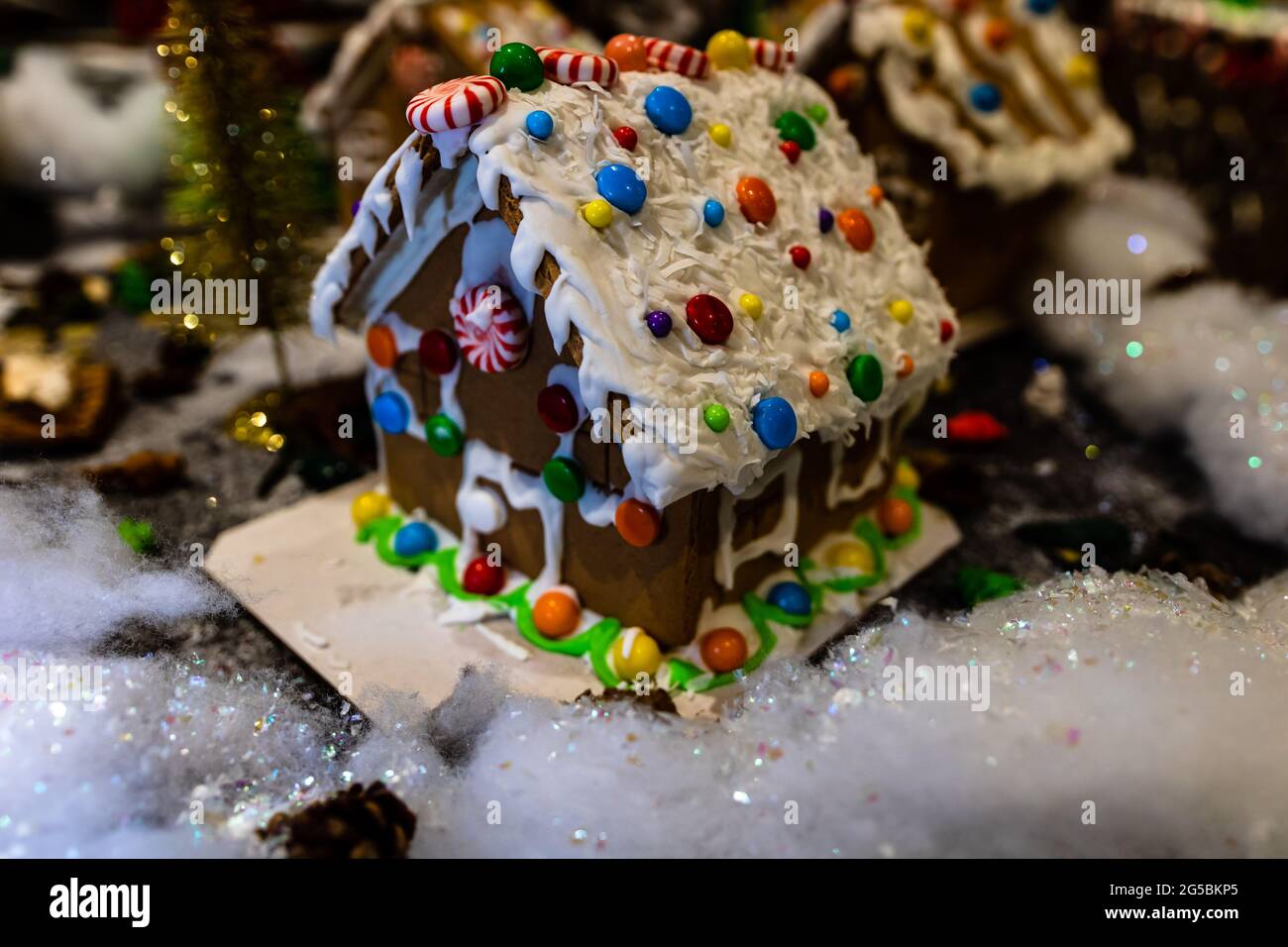 Colorful gingerbread house isolated on blurred background with C Stock