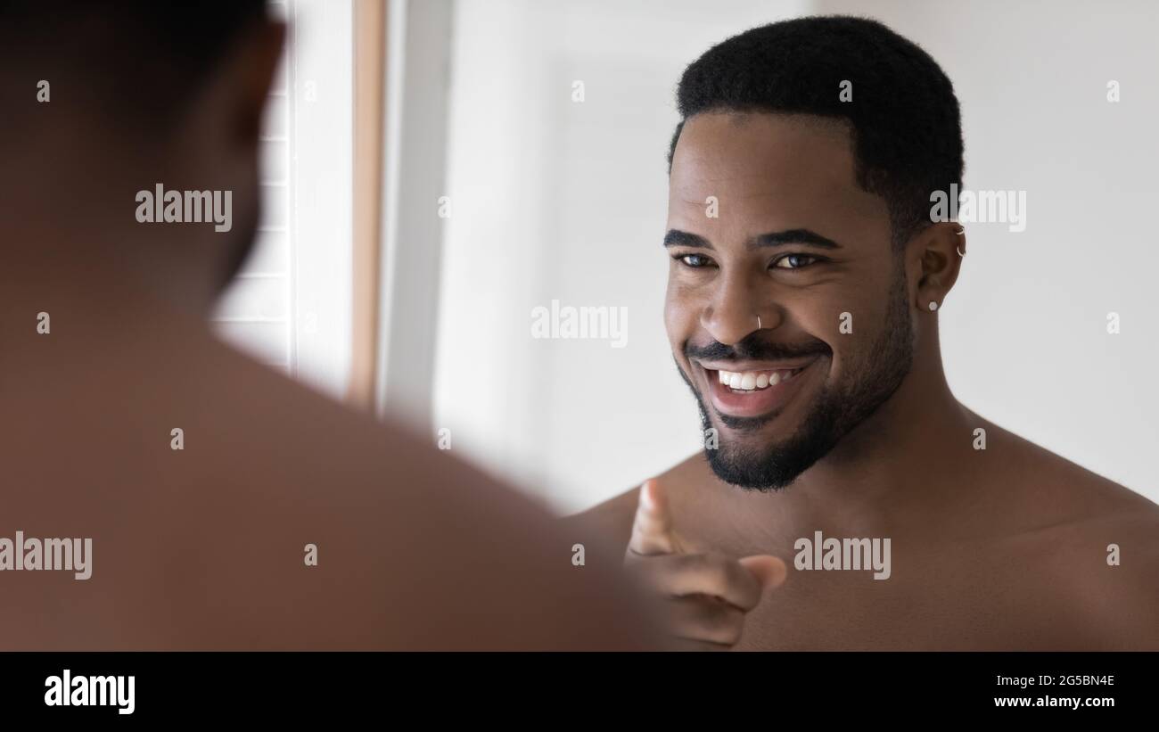 Happy handsome Black metrosexual guy with facial piercing Stock Photo