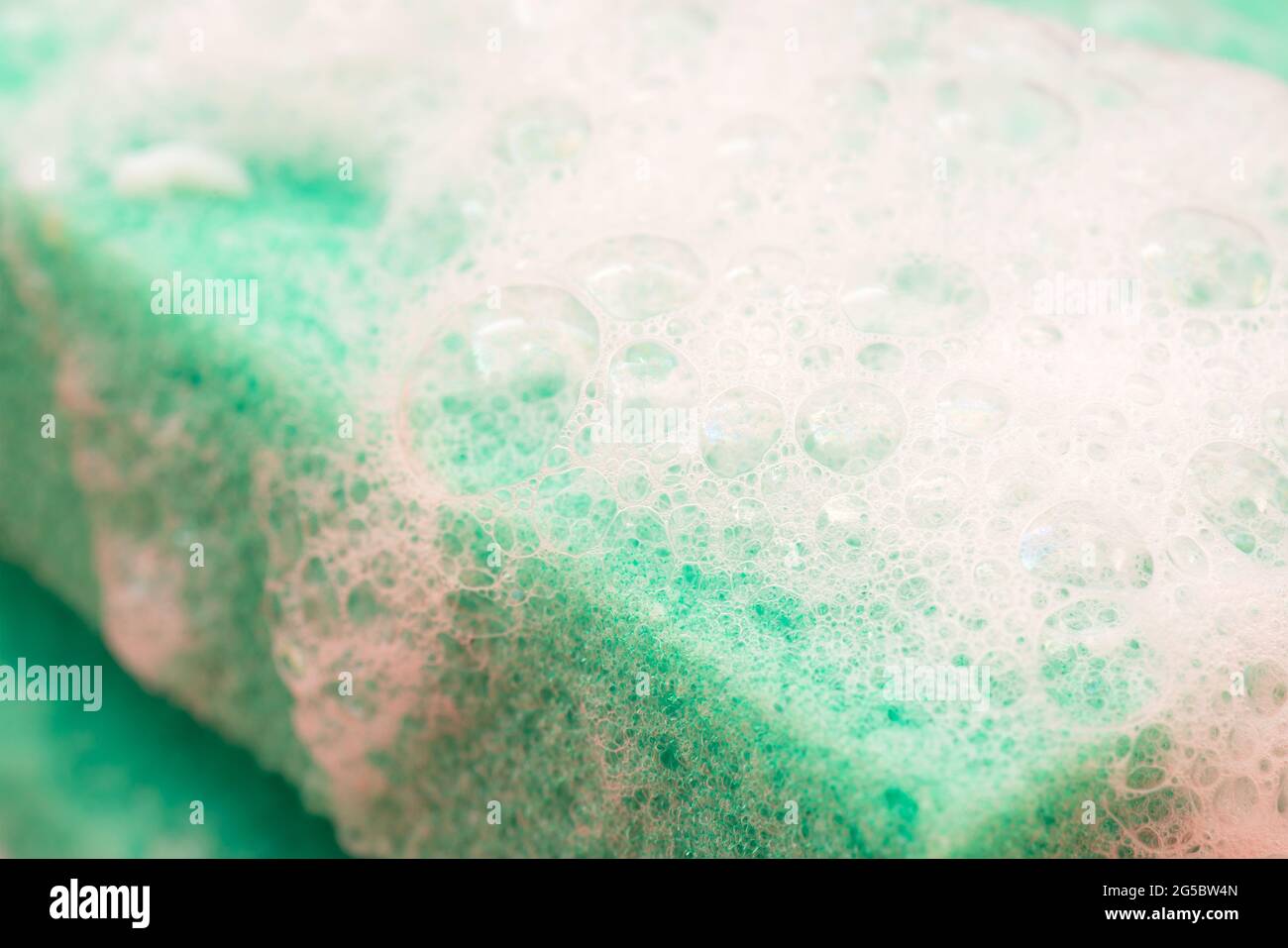Soap suds on a green sponge Stock Photo