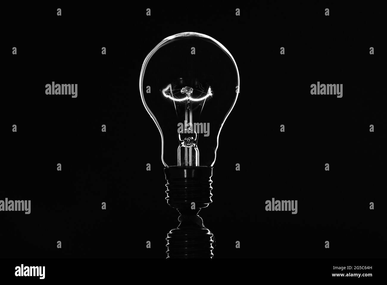 Light bulb on black background Stock Photo - Alamy