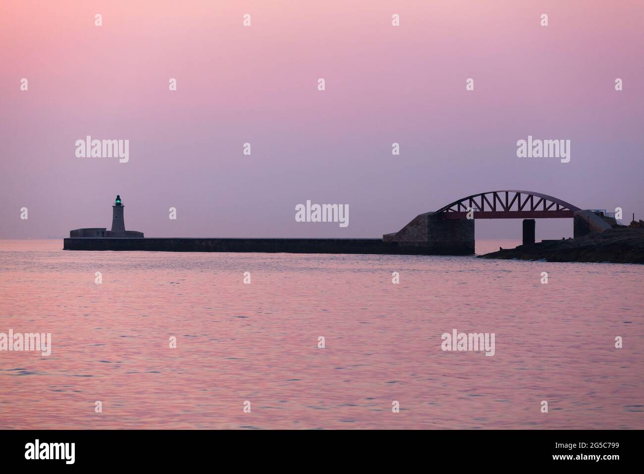 St. Elmo bridge and Lighthouse tower with green light at night