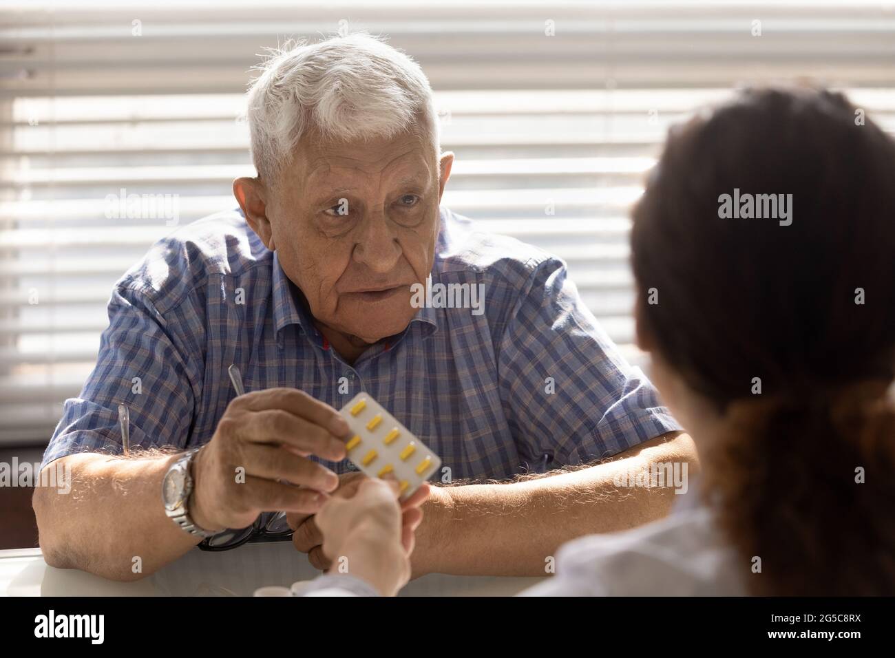 Old male patient consult with doctor about medications Stock Photo