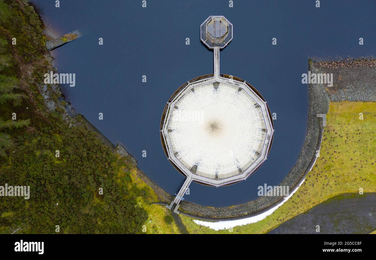 Recent snow and heavy rain has filled Scottish reservoirs to capacity. Circular spillway at Whiteadder reservoir now running full, East Lothian Stock Photo