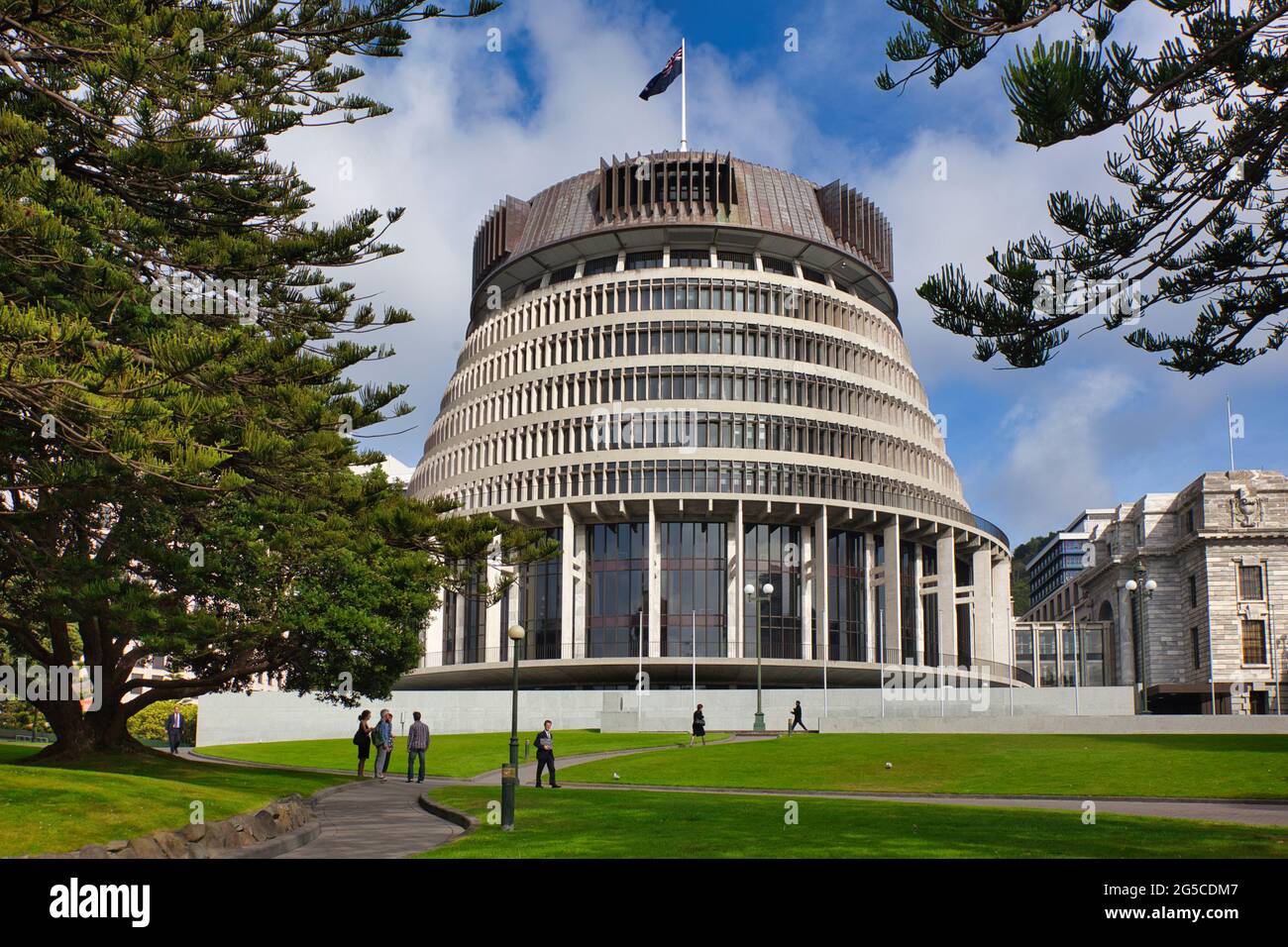 The Beehive Parliament building framed by trees and lawn infront with