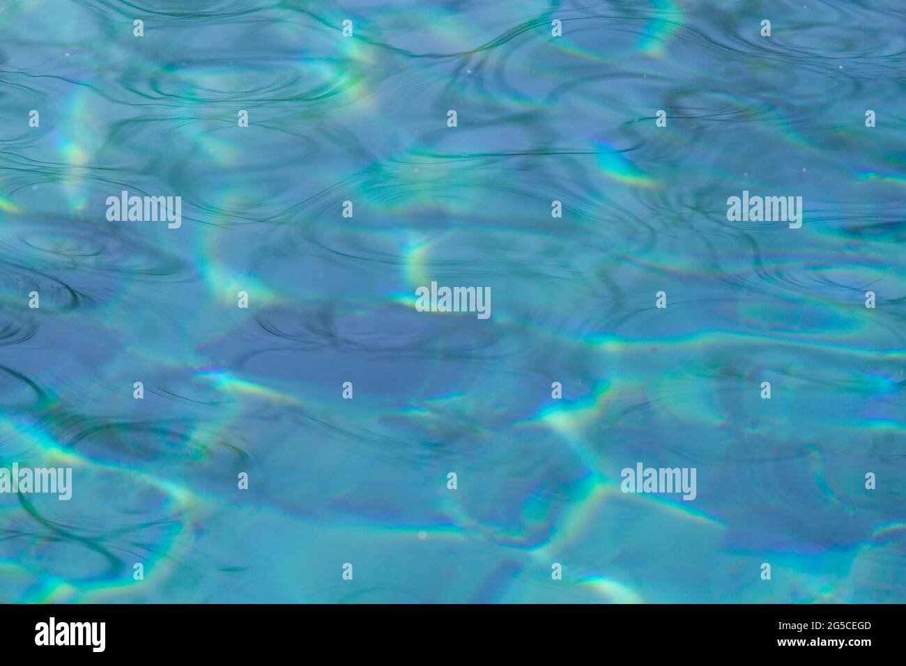 Blue water background with reflections of the sun Stock Photo - Alamy