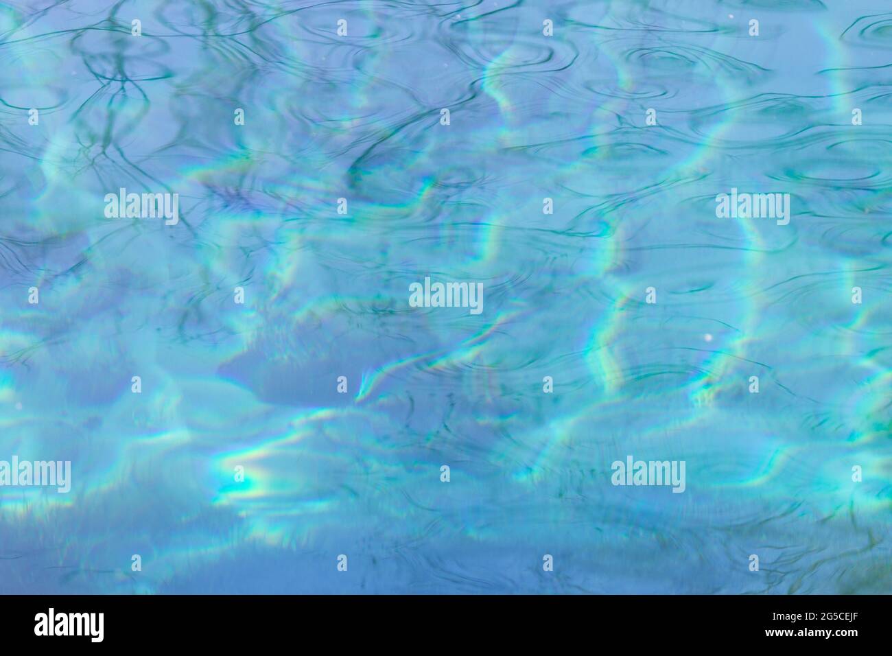 Blue water background with reflections of the sun Stock Photo - Alamy