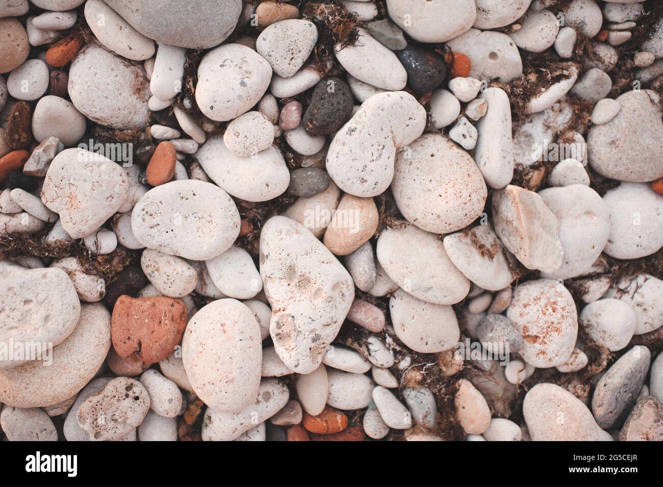 Different color beach stone pebbles at seashore outdoors top view