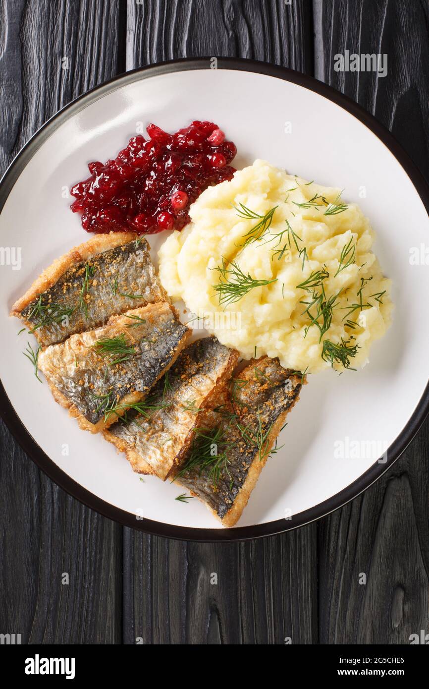 Stekt stromming or fried herring is a hearty Swedish food with boiled  potatoes closeup in the plate on the table. Vertical top view from above  Stock Photo - Alamy