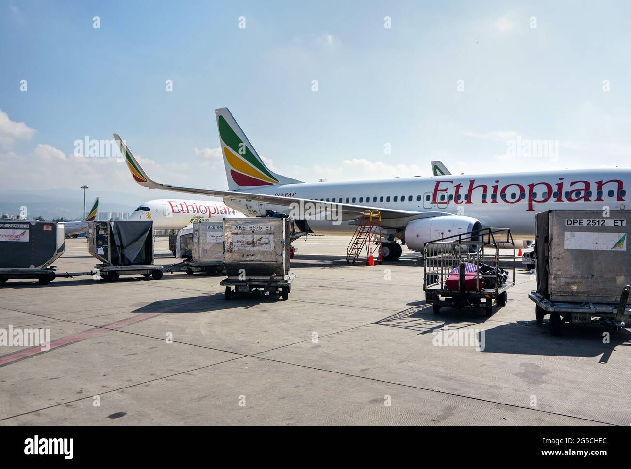 Addis Ababa, Ethiopia - April 23, 2019: Ethiopian airlines Boeing 737 waiting at ground on sunny day, another A350 aircraft behind. EAL are largest Stock Photo