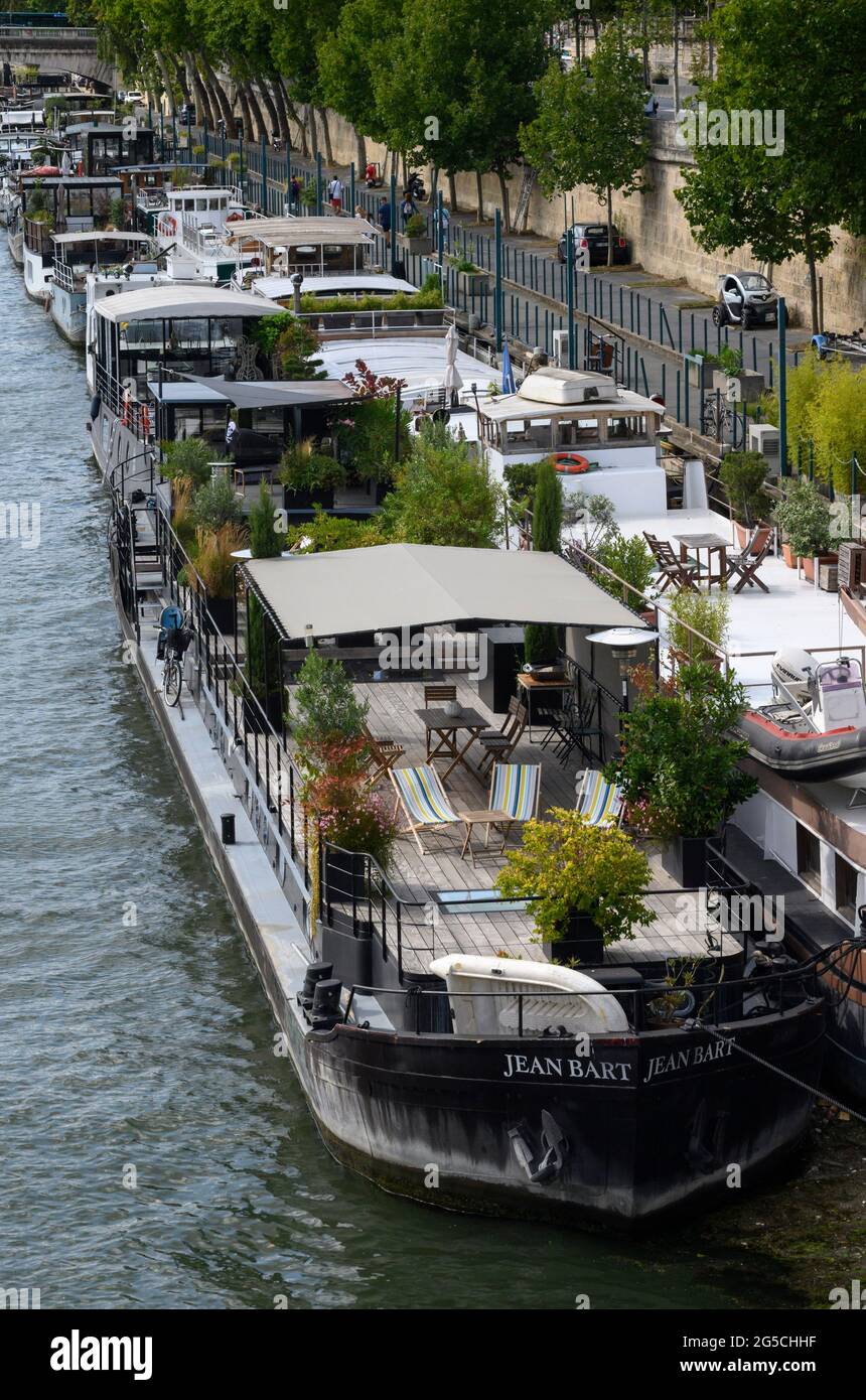 PARIS, FRANCE - AUGUST 20 2019 : Peniches along quay of Seine River in Paris. Stock Photo