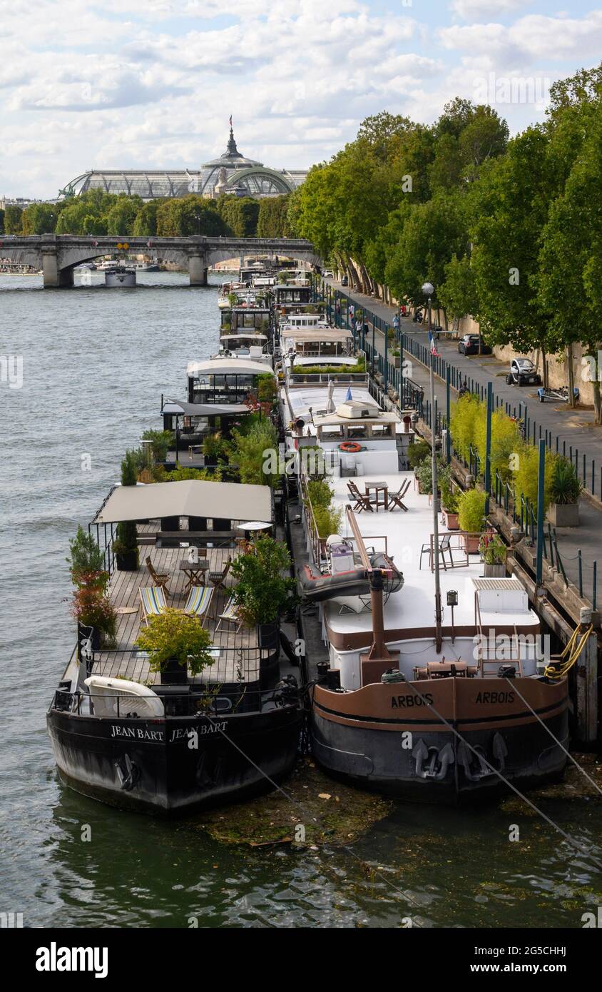 PARIS, FRANCE - AUGUST 20 2019 : Peniches along quay of Seine River in Paris. Stock Photo