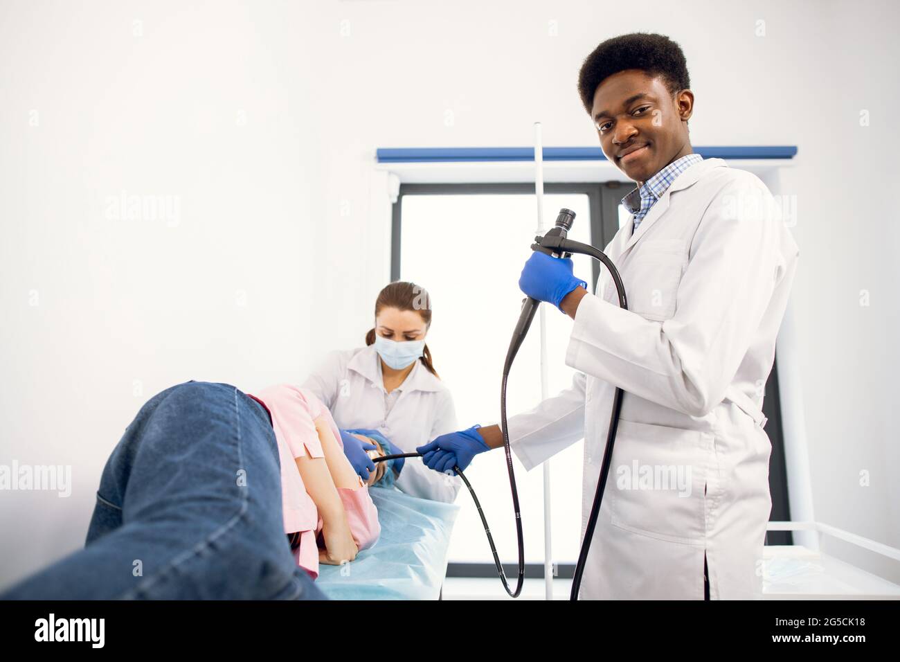 African male doctor endoscopist surgeon in medical suit, and gloves