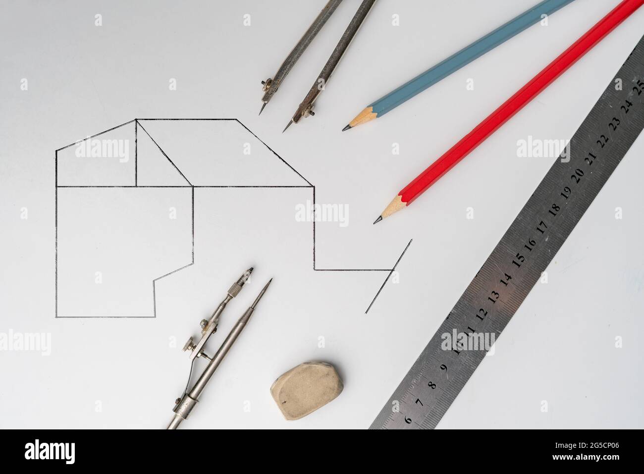 drawing a plan on a color surface using the pencil, ruler, compass and ...