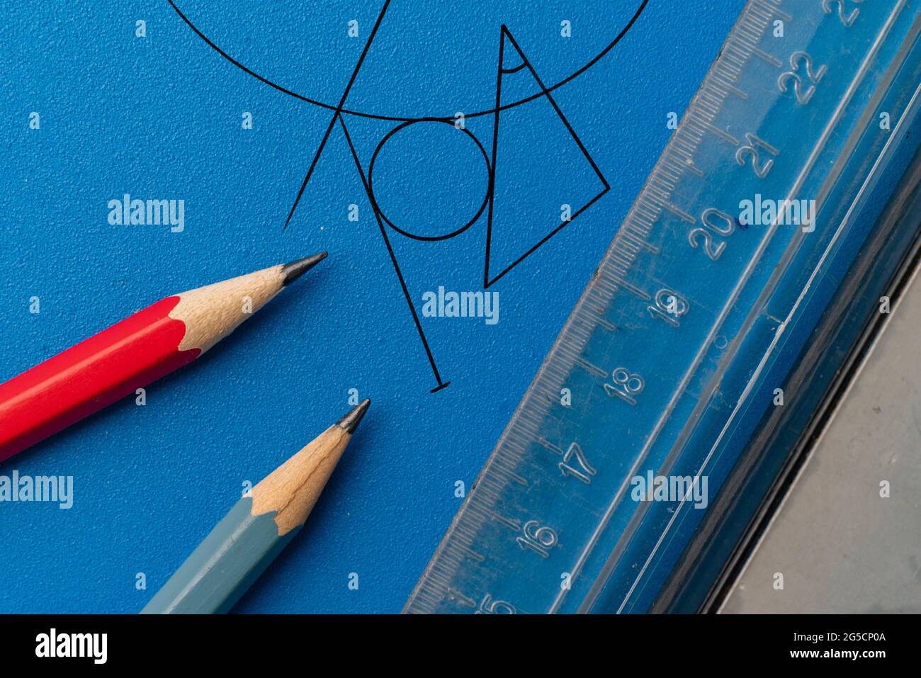 drawing a plan on a color surface using the pencil, ruler, compass and ...