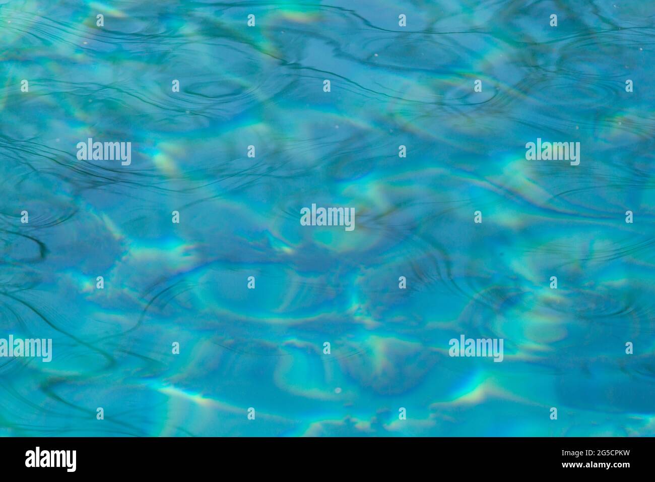 Blue water background with reflections of the sun Stock Photo - Alamy