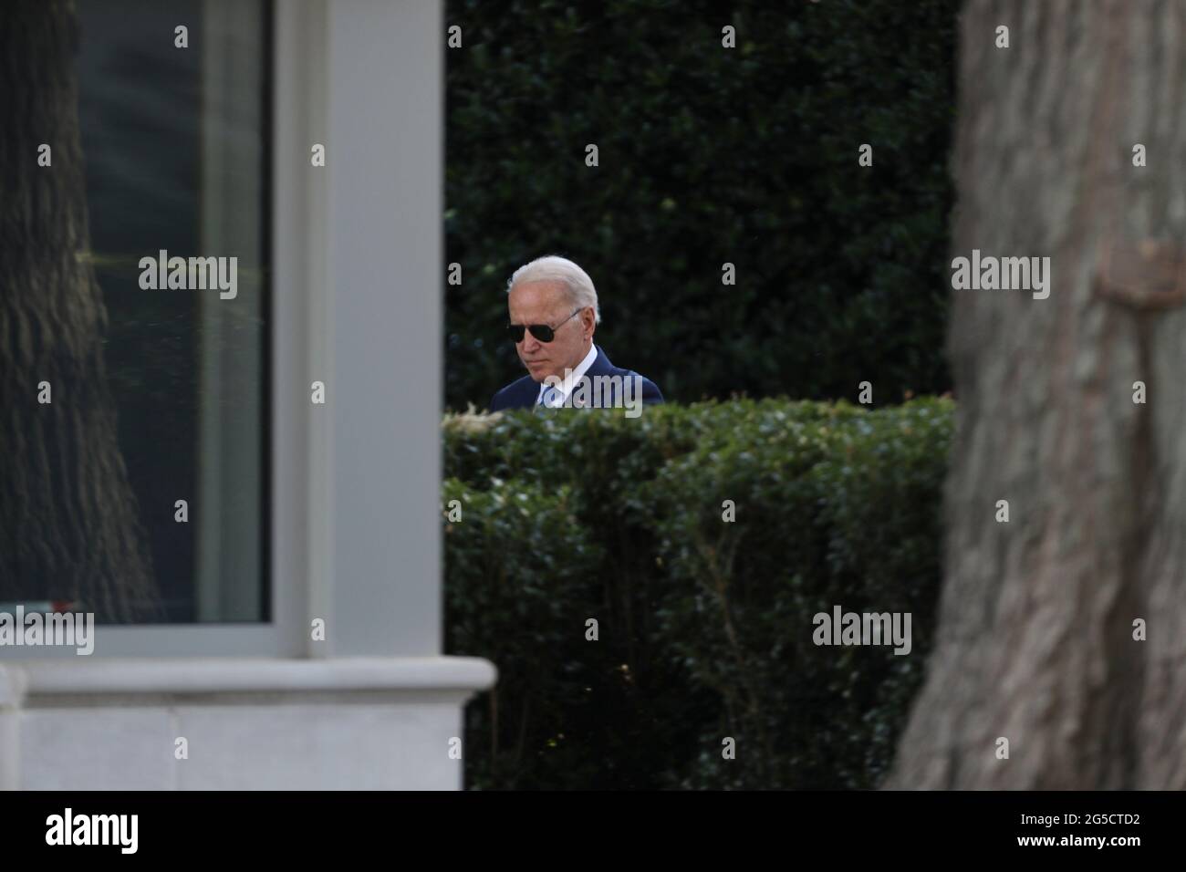 United States President Joe Biden walks on the South Lawn of the White  House before boarding Marine One on Friday, June 25, 2021 in Washington,  DC., for a trip to Camp David,