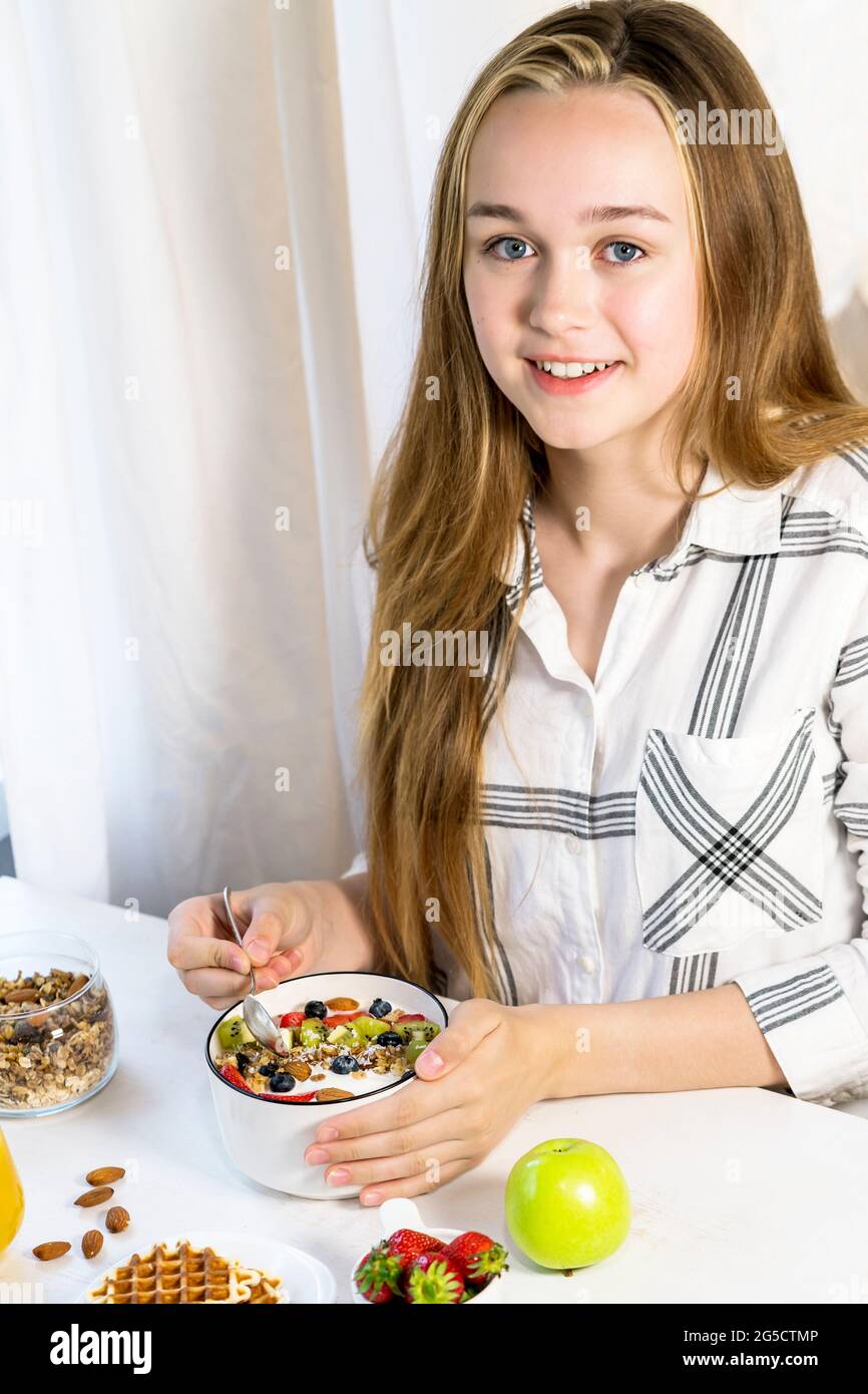 Young woman eating yogurt model hires stock photography and images Alamy