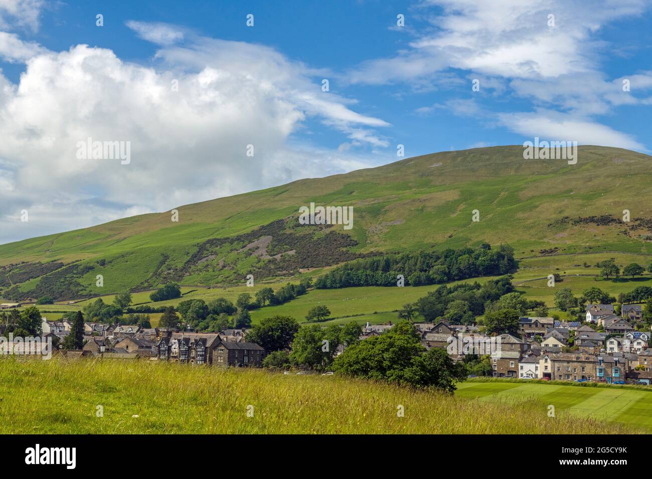 Winder Fell rising above the rural market town of Sedbergh in the Howgill Fells Cumbria North West England Stock Photo