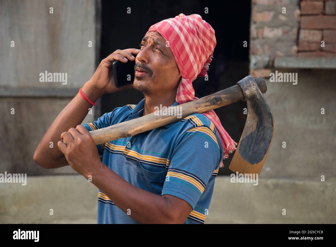 Indian farmer talking on smart phone Stock Photo
