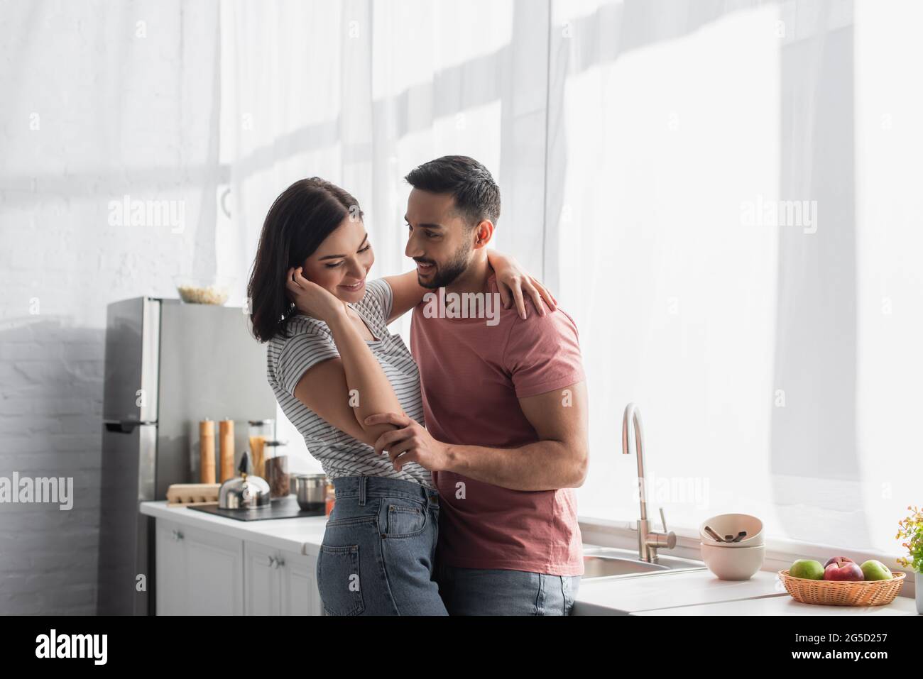 Young couple hugging in hi-res stock photography and images - Alamy