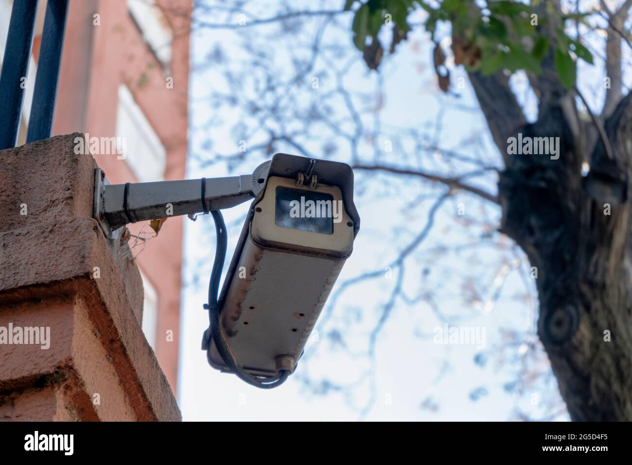 Outdoor surveillance or security camera installed on the external wall of a building. Concept security, remote surveillance, surveillance. Stock Photo