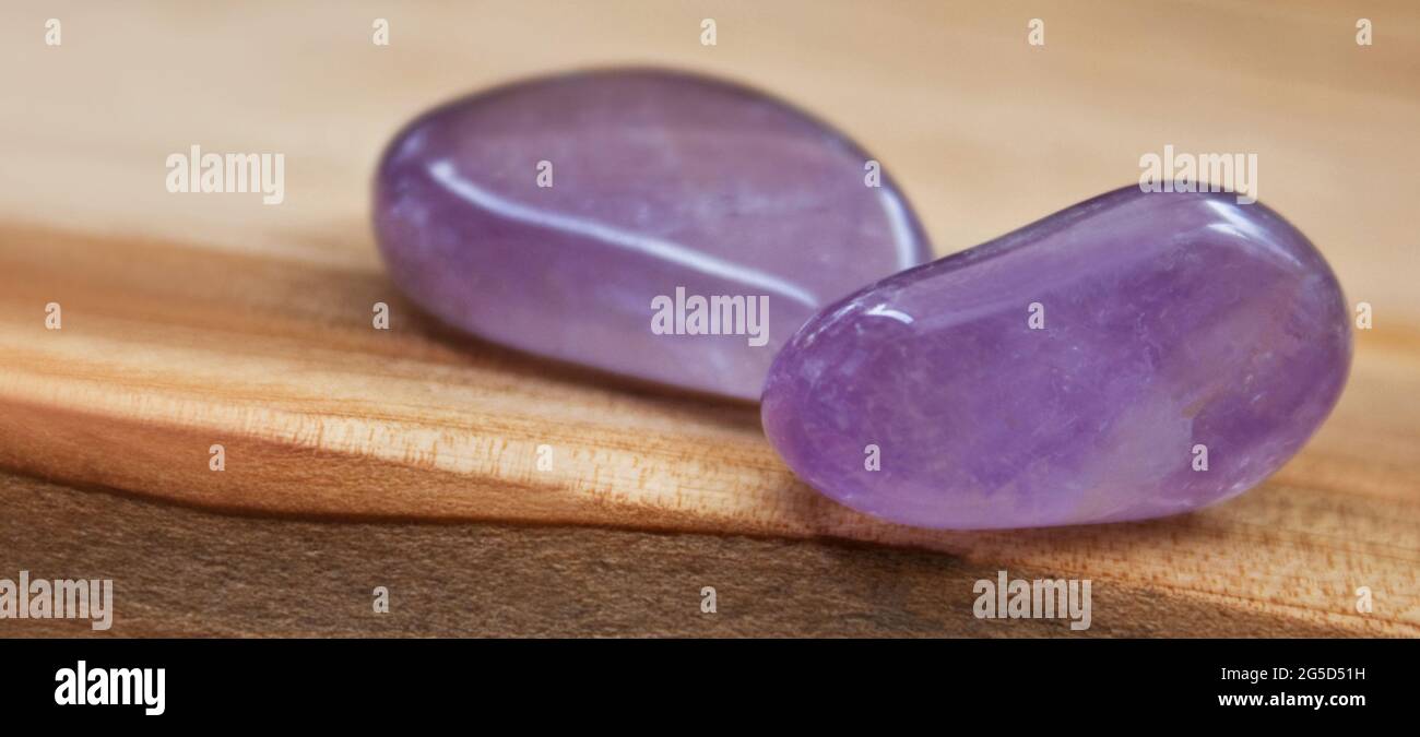 Amethyst against wooden background close up Stock Photo