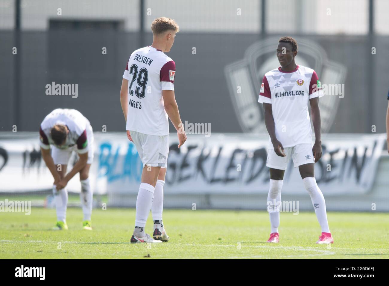 Dresden, Germany. 26th June, 2021. Football: Test match, SG Dynamo - Hertha BSC II, AOK PLUS Walter-Fritzsch-Akademie. Dynamo's Meissa Diop (r) and Dynamo's Phil Harres (m) stand on the pitch during the match. Credit: Sebastian Kahnert/dpa-Zentralbild/dpa - IMPORTANT NOTE: In accordance with the regulations of the DFL Deutsche Fußball Liga and/or the DFB Deutscher Fußball-Bund, it is prohibited to use or have used photographs taken in the stadium and/or of the match in the form of sequence pictures and/or video-like photo series./dpa/Alamy Live News Stock Photo