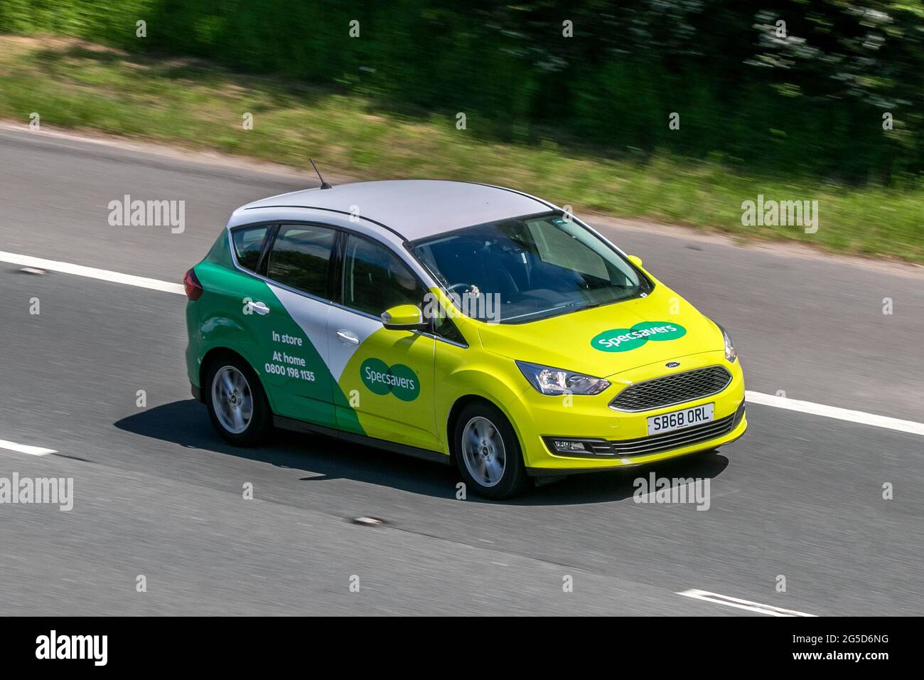 A Specsavers Opticians car driving on the M6 motorway near Preston in Lancashire, UK Stock Photo