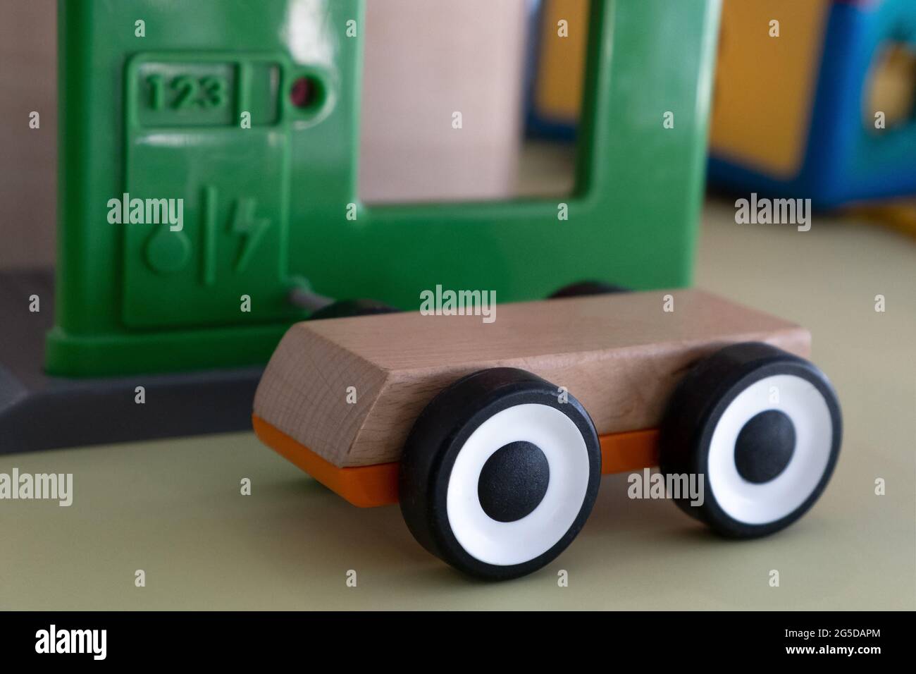 Wooden toy car with electrical cable plugged. Save energy concept Stock