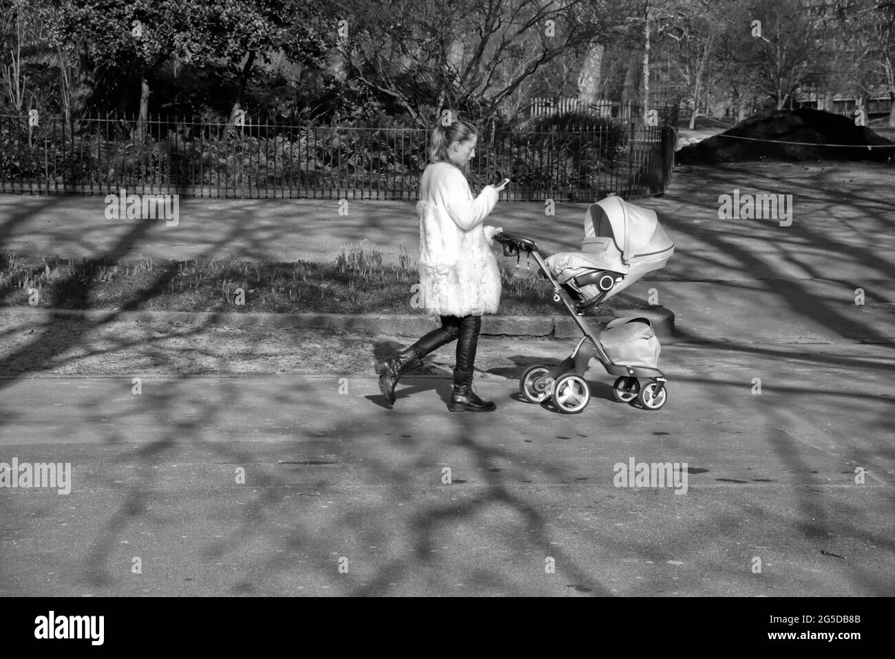 Woman pushing pram phone Black and White Stock Photos & Images Alamy