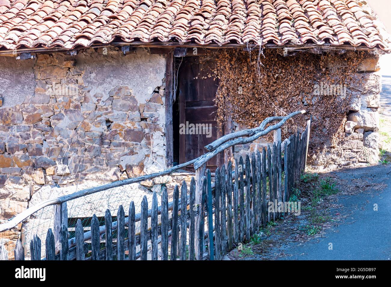 View of an apparently abandoned old house in a village in Asturias, Spain.Photograph with a predominantly brownish tone and shot in horizontal format. Stock Photo