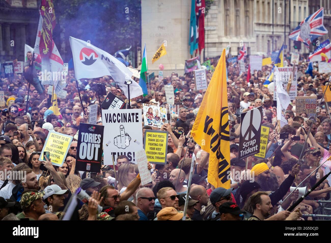 London, UK. 26th June, 2021. Protesters march down Whitehall past Downing Street. Thousands of people marched to raise their concerns regarding government legislation centred around vaccinations and freedom to travel. Credit: Andy Barton/Alamy Live News Stock Photo