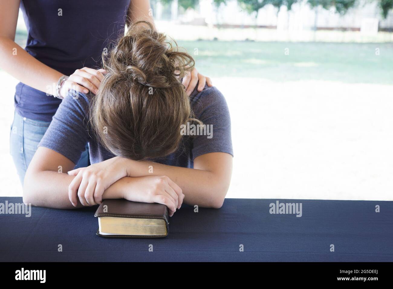 Comforting a Distressed Woman During a Bible Study Stock Photo