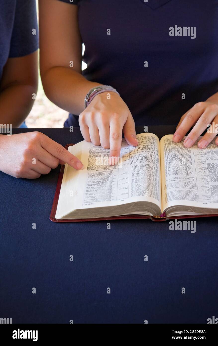 A Friend Helping Someone Study the Bible Stock Photo Alamy