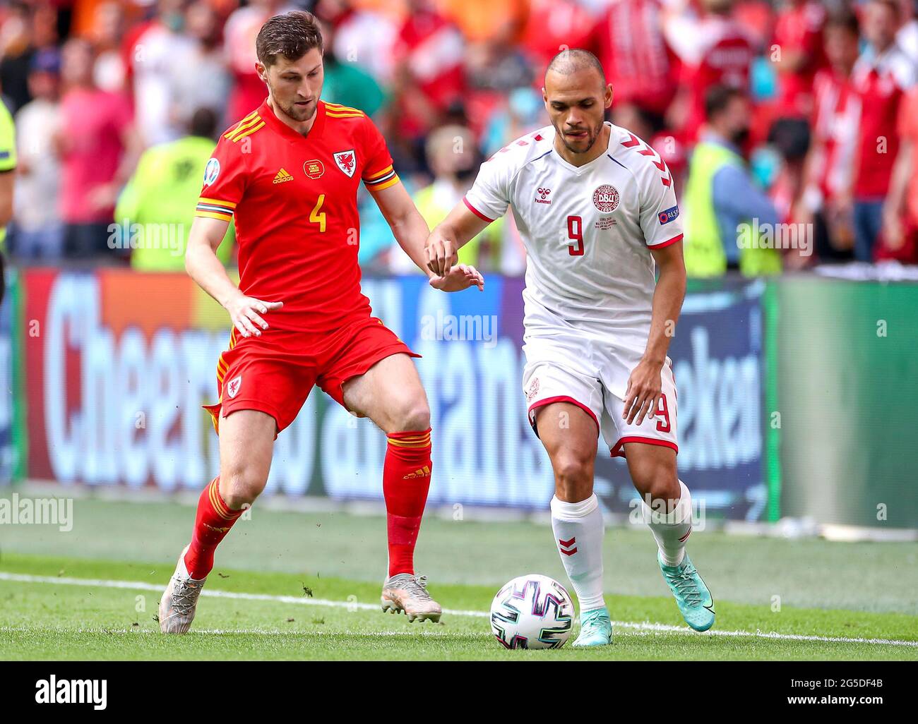 Wales' Ben Davies (left) and Denmark's Martin Braithwaite battle for the ball during the UEFA Euro 2020 round of 16 match held at the Johan Cruijff ArenA in Amsterdam, Netherlands. Picture date: Saturday June 26, 2021. Stock Photo