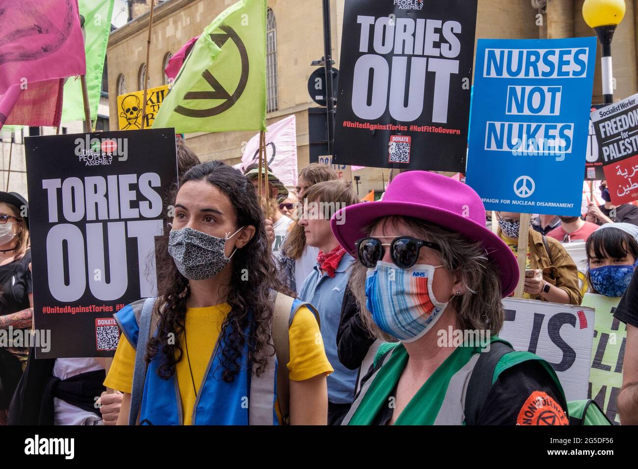 London, UK. 26th June 2021. Over five thousand joined the People's Assembly march through London against the failures of the Tory government during the pandemic, acting too late, handing out contracts to cronies and failing to reward key workers for their sacrifices. They demanded a 'new normal' with an end to NHS privatisation, decent housing, real action over climate change, decent housing, an end to unfair employment practices and the sacking of corrupt politicians. Peter Marshall/Alamy Live News Stock Photo