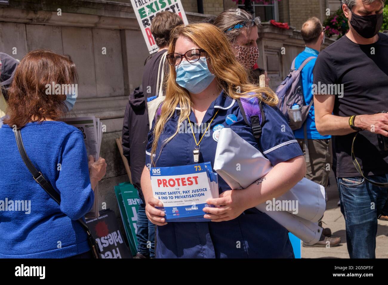 London, UK. 26th June 2021. Nurse protests for the NHS.  Over five thousand joined the People's Assembly march through London against the failures of the Tory government during the pandemic, acting too late, handing out contracts to cronies and failing to reward key workers for their sacrifices. They demanded a 'new normal' with an end to NHS privatisation, decent housing, real action over climate change, decent housing, an end to unfair employment practices and the sacking of corrupt politicians. Peter Marshall/Alamy Live News Stock Photo
