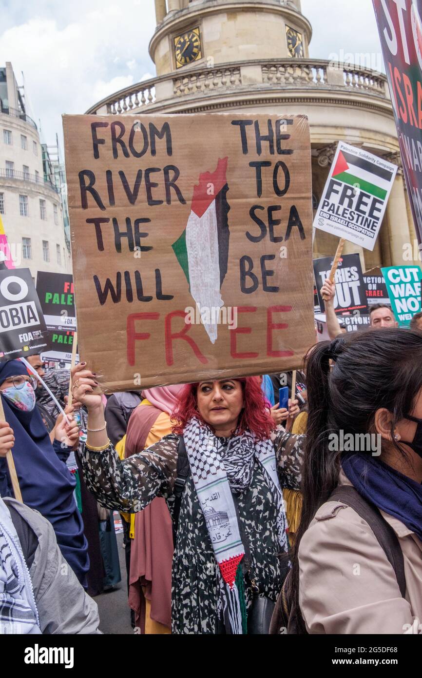 London, UK. 26th June 2021. From the River to the Sea (Palestine) will be Free. Over five thousand joined the People's Assembly march through London against the failures of the Tory government during the pandemic, acting too late, handing out contracts to cronies and failing to reward key workers for their sacrifices. They demanded a 'new normal' with an end to NHS privatisation, decent housing, real action over climate change, decent housing, an end to unfair employment practices and the sacking of corrupt politicians. Peter Marshall/Alamy Live News Stock Photo