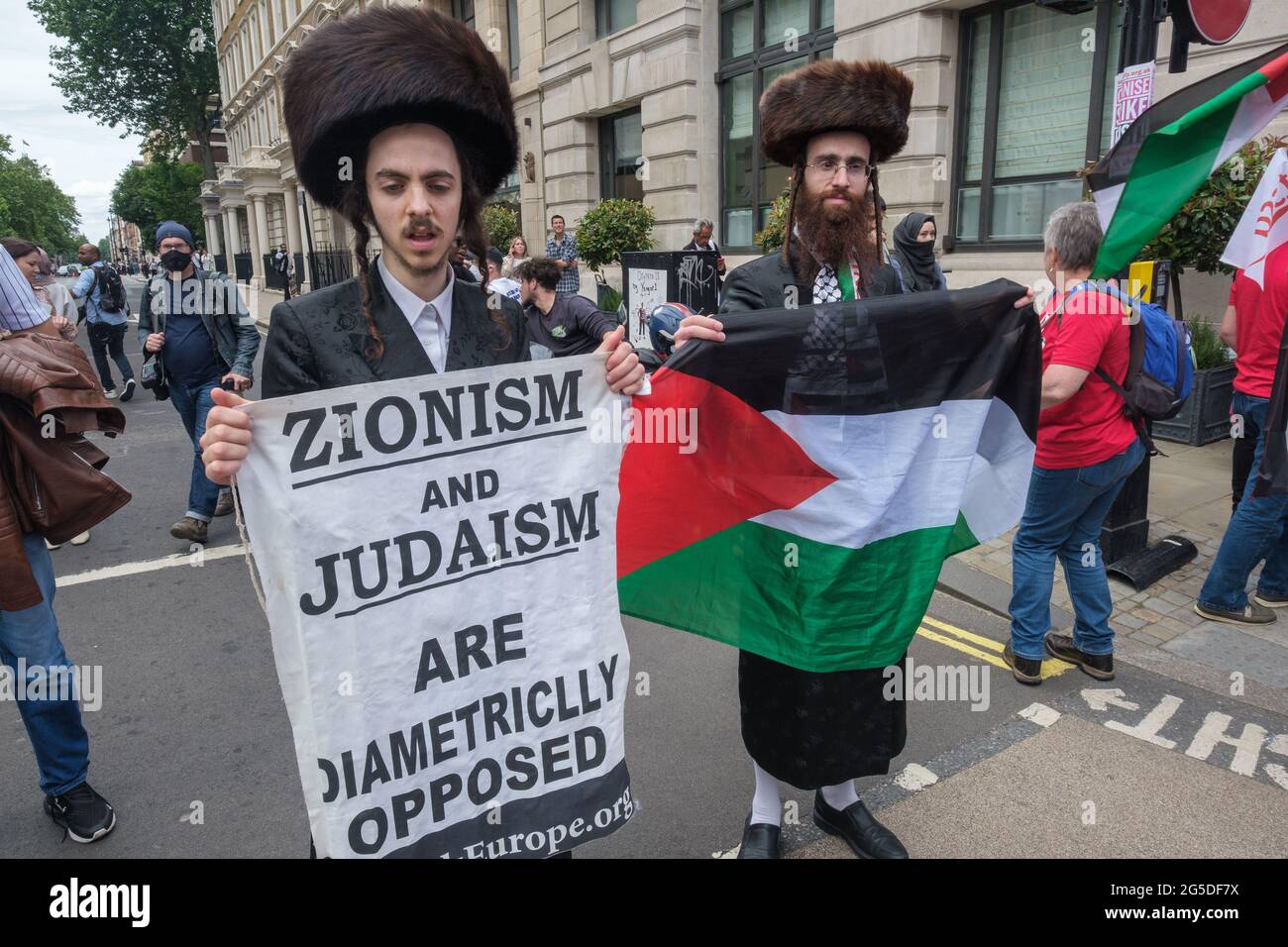 London, UK. 26th June 2021. Neterei Karta ultra-Orthodox views support freedom for Palestine. Over five thousand joined the People's Assembly march through London against the failures of the Tory government during the pandemic, acting too late, handing out contracts to cronies and failing to reward key workers for their sacrifices. They demanded a 'new normal' with an end to NHS privatisation, decent housing, real action over climate change, decent housing, an end to unfair employment practices and the sacking of corrupt politicians. Peter Marshall/Alamy Live News Stock Photo