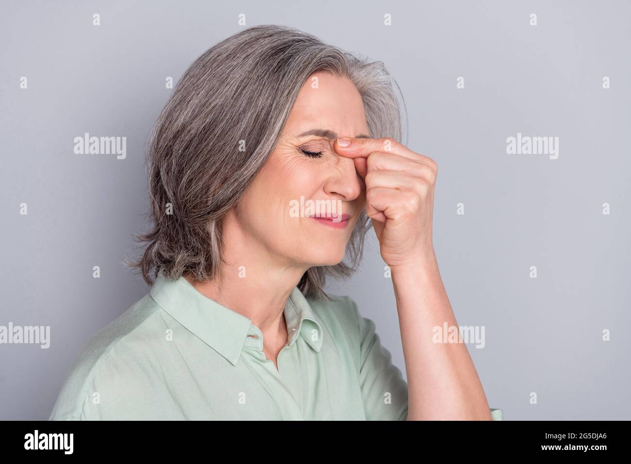Photo of unhappy upset sad negative mood businesswoman suffer headache overworked isolated on grey color background Stock Photo