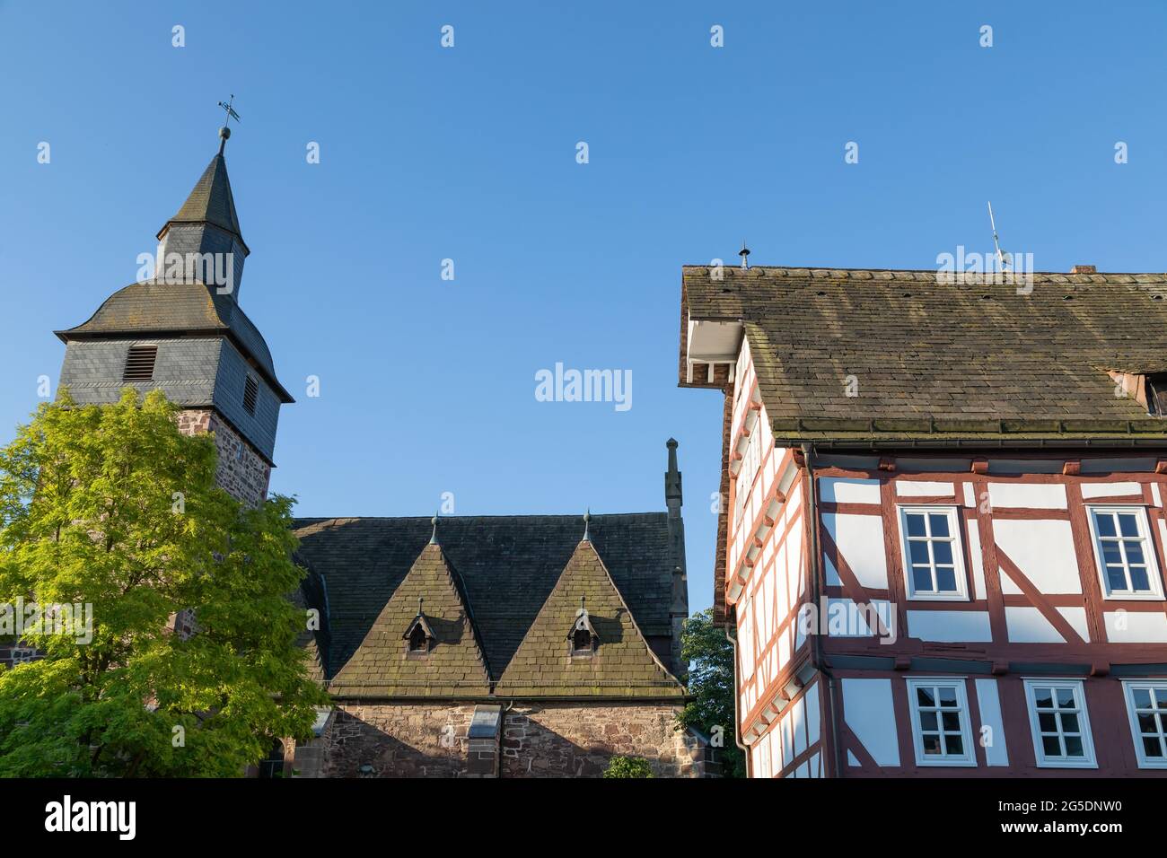 half-timbered house and church in small town Trendelburg Stock Photo