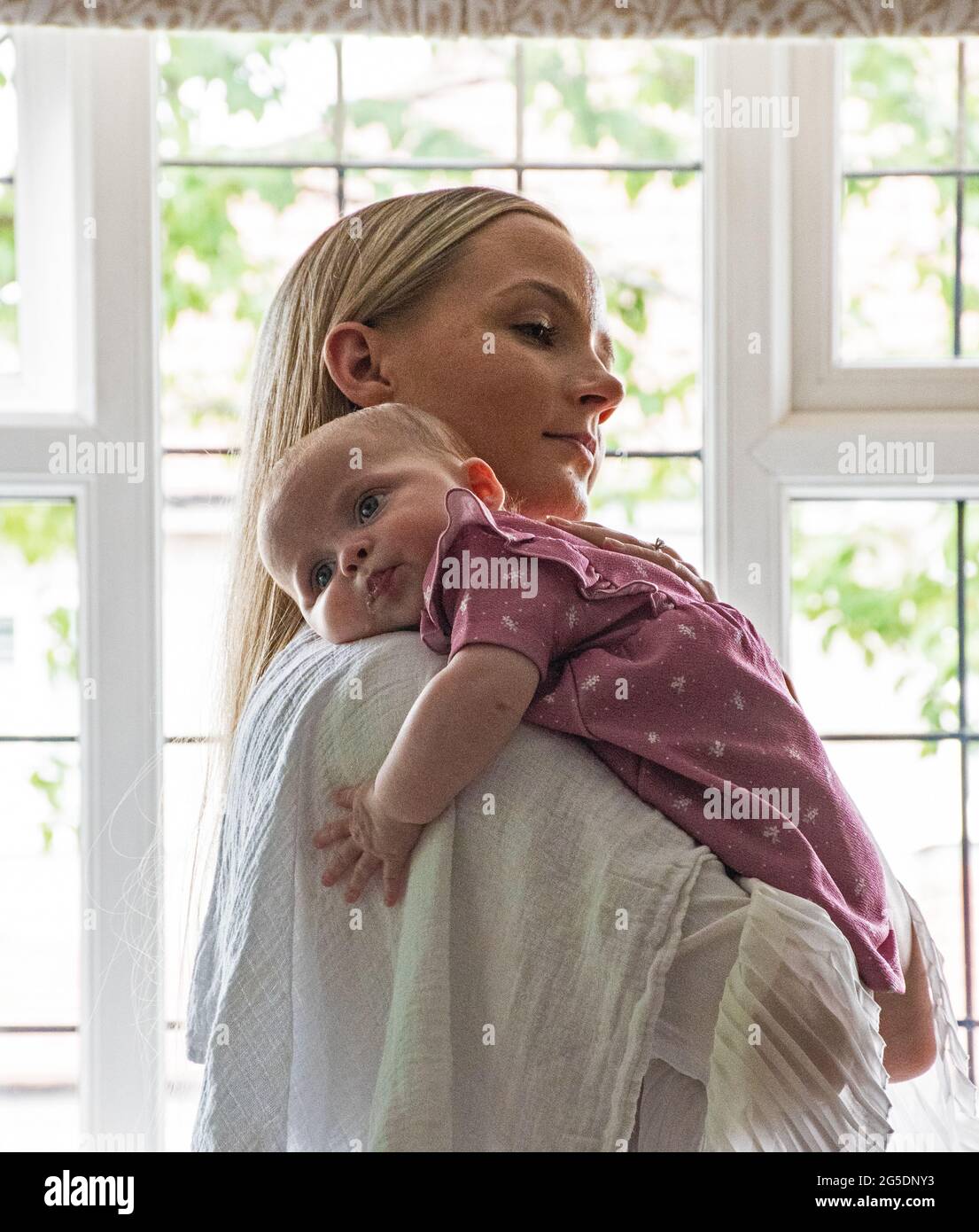 Young mother and sleeping baby Stock Photo - Alamy