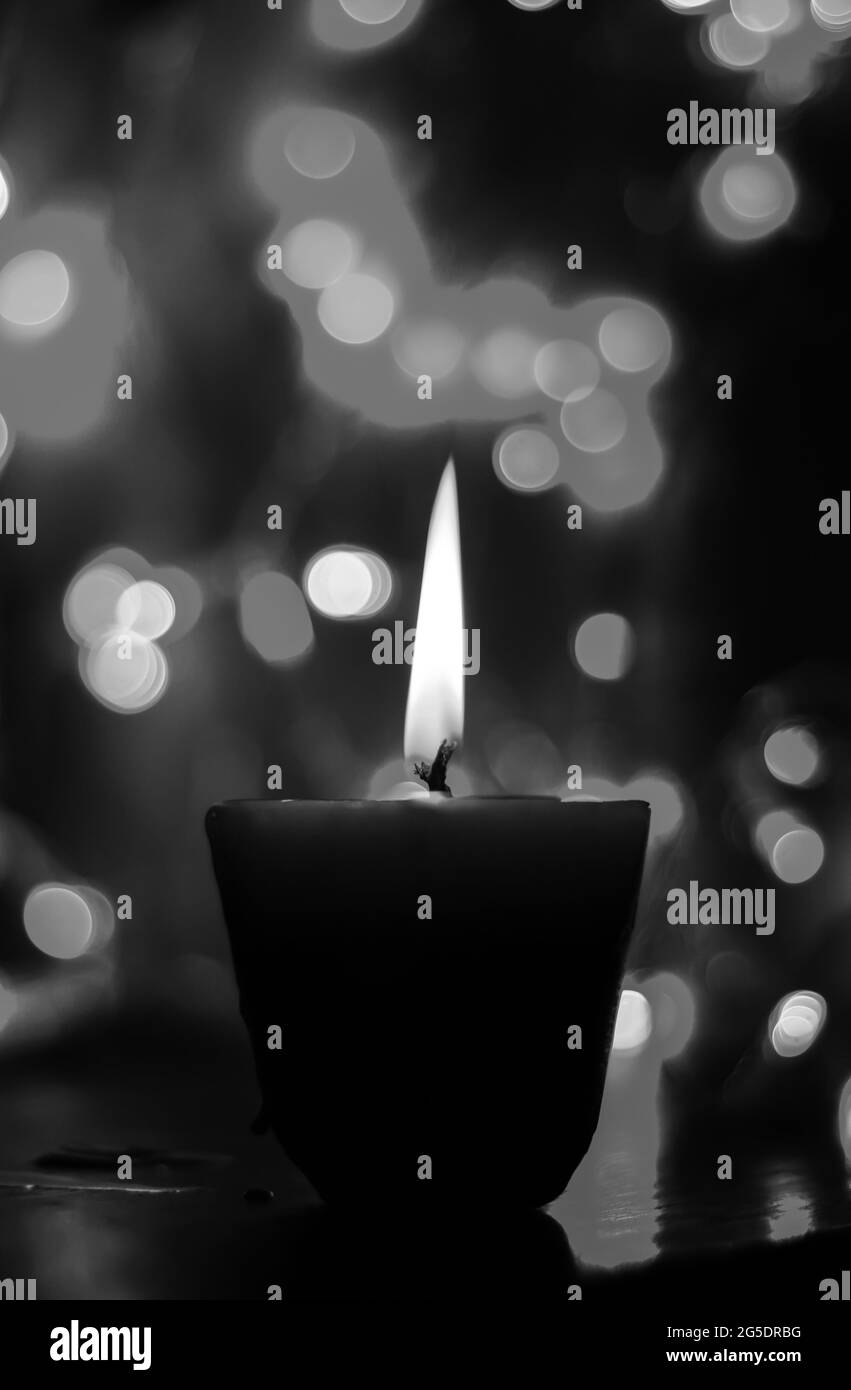 Candle lights in darkness with colorful light effects and bokeh for