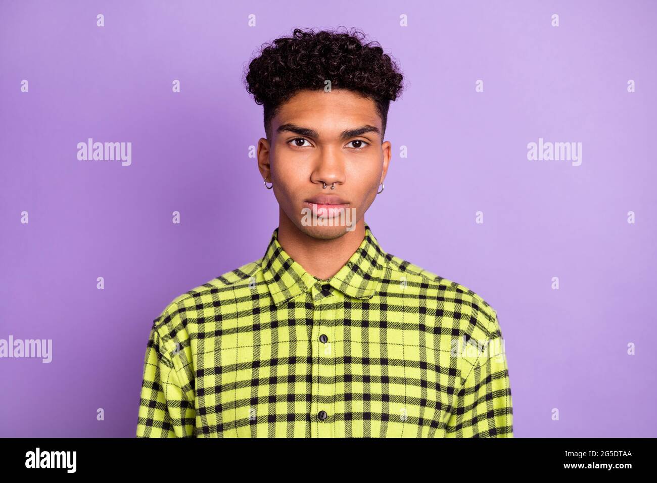 Photo of serious dark skin charming young man pierced ears nose wear plaid  shirt isolated on purple color background Stock Photo - Alamy