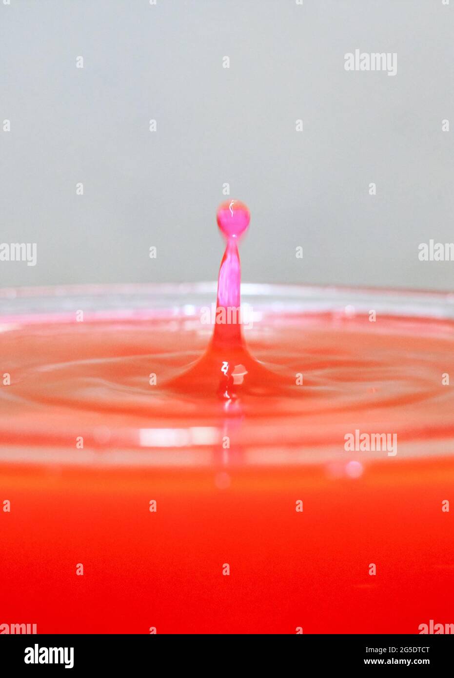 close up of colorful water droplets falling. Waterdrop splash into the ...