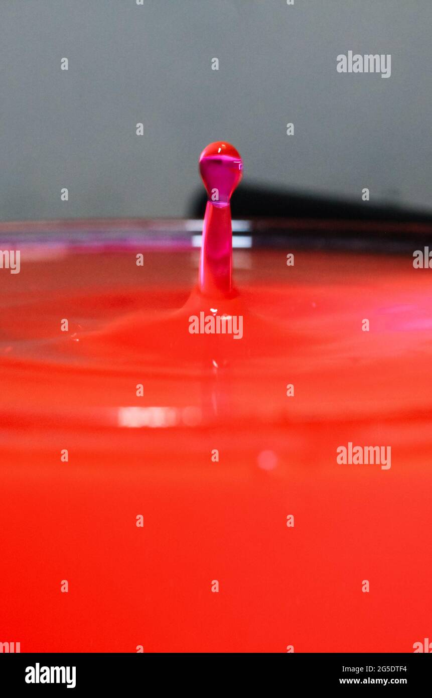 close up of colorful water droplets falling. Waterdrop splash into the ...