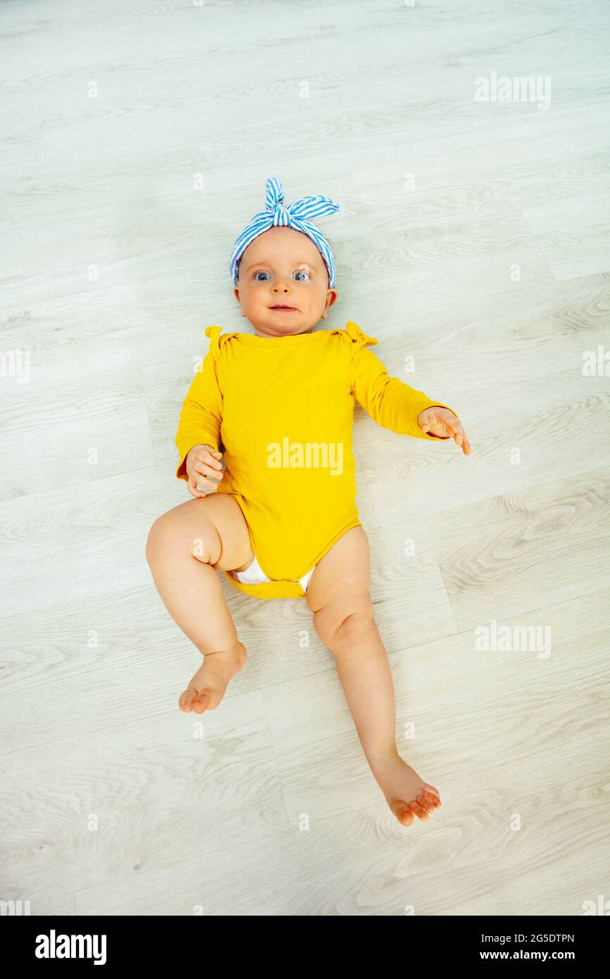 Beautiful baby girl with blue bow view from above Stock Photo