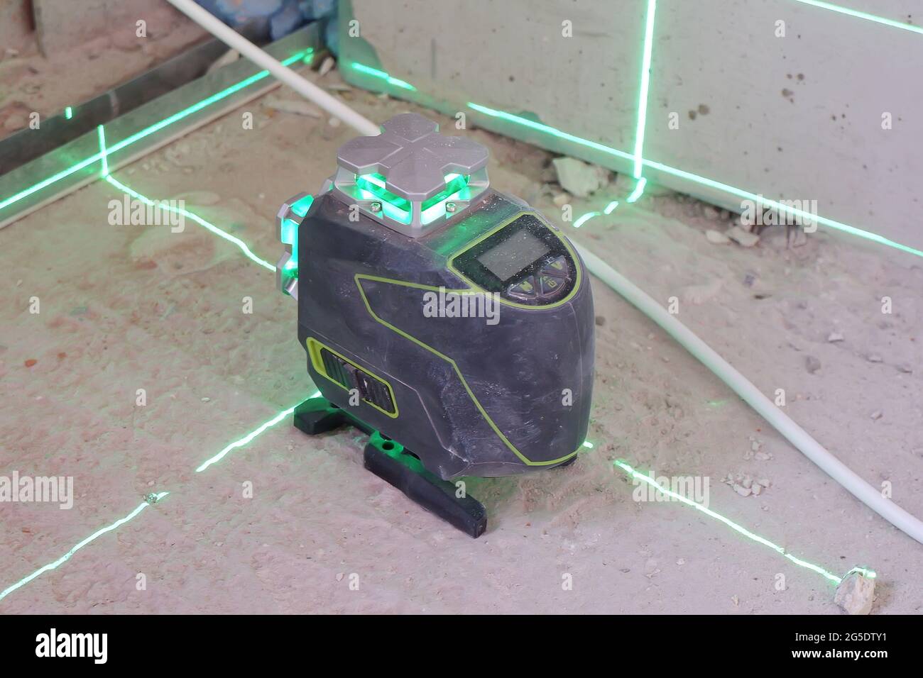 the laser level stands on the floor and draws levels for the